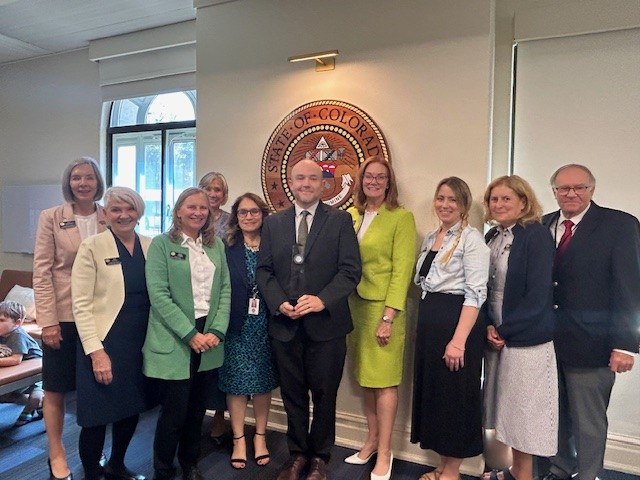 State Board of Education members pose with Chris Reynolds, 2024 Milken Educator Award winner.