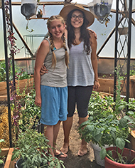 Megan Cleaver, right, stands with seventh-grader Laura Morfitt, in the greenhouse at Mountain Valley School in Saugache, where Megan helped get the greenhouse up and running.