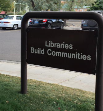 Signage seen as leaving a library, Libraries build community.