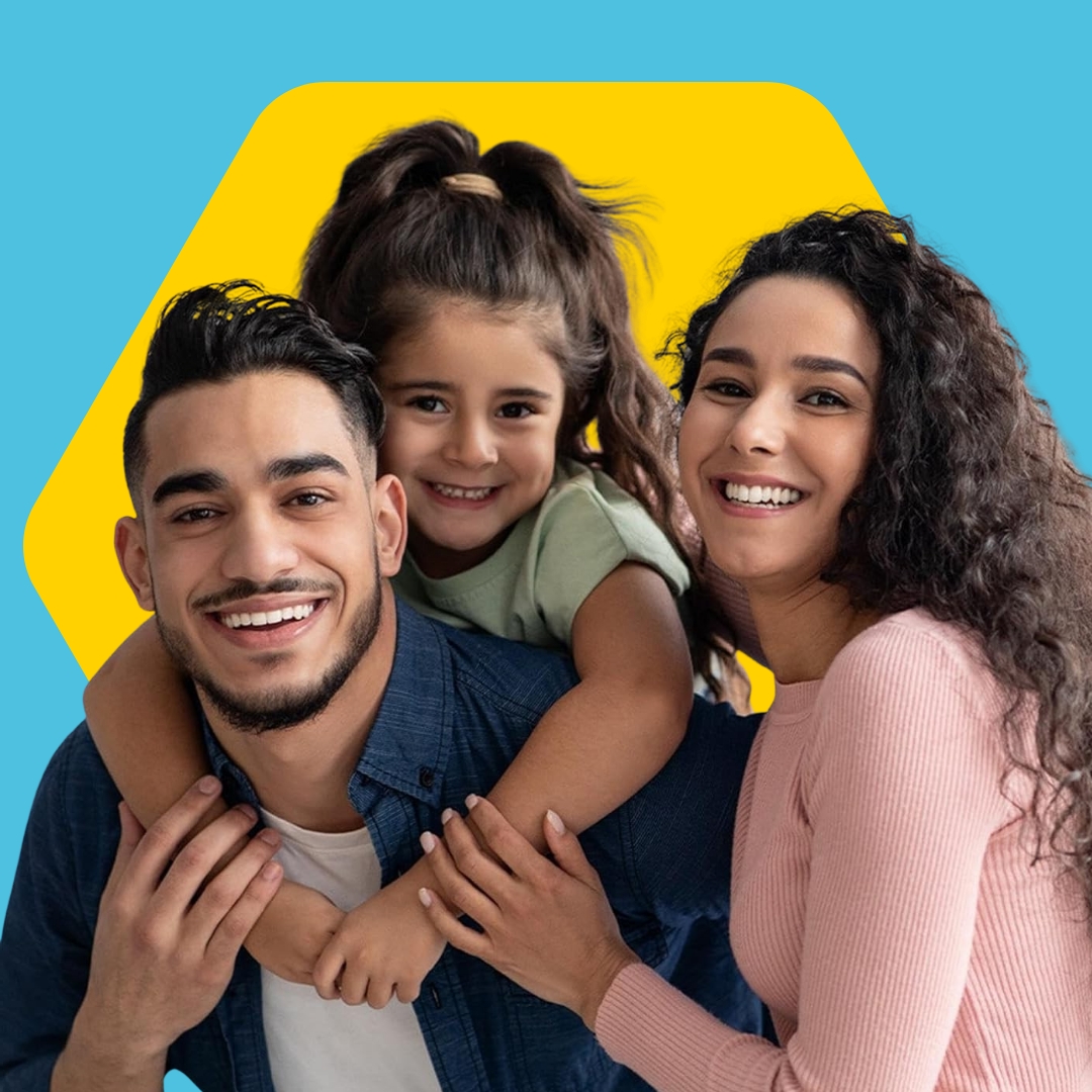 A man woman and child with dark hair smiling at the camera