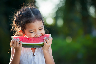 Young girl eating watermelon